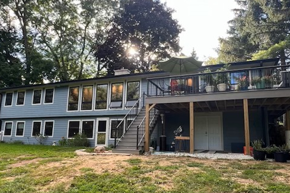 Ranch exterior back after remodeling.